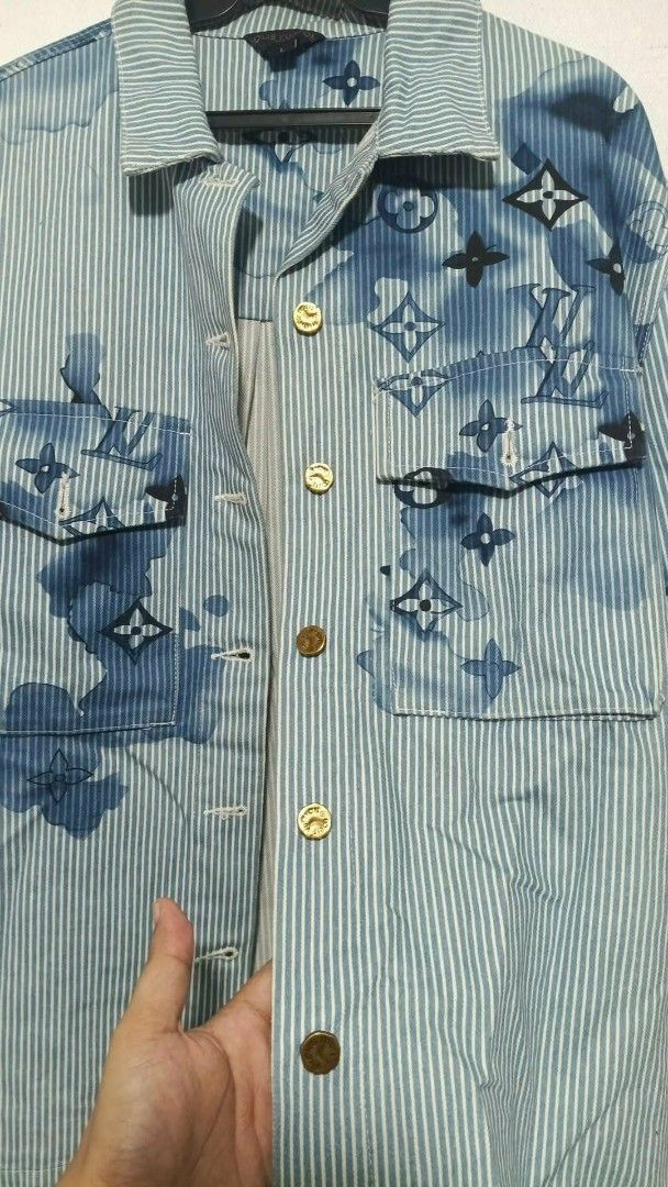 Louis Vuitton Striped Denim Jacket with Monogram Print (Category: Luxury Apparel) located in San Fernando. Submitted by anal.cris (Listing ID 1461575717, Image 3). Description: - Iconic LV monogram denim jacket - Stylish blue and white stripe pattern - Classic button-up front with chest pockets - Gold buttons featuring the LV logo - A definite head-turner and wardrobe essential.