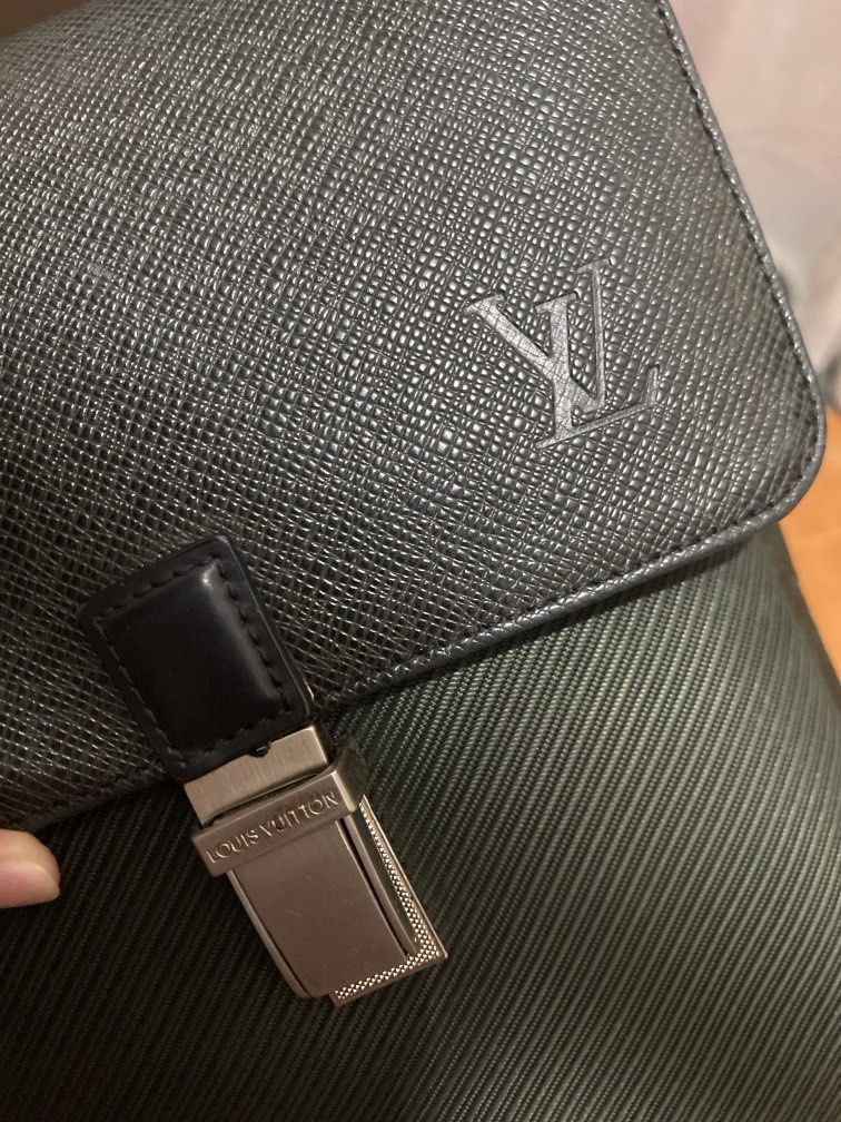 Louis Vuitton Taiga Leather/canvas Sling Bag (Category: Luxury Bags & Wallets) located in Manila. Submitted by junejanuary (Listing ID 1461748187, Image 3). Description: - Louis Vuitton Black Taiga leather clutch - Features iconic LV monogram embossed on the front - Secure clasp closure with Louis Vuitton branding - Perfect for carrying your essentials - Interior is clean and well-maintained - Minor signs of wear on hardware, consistent with norm