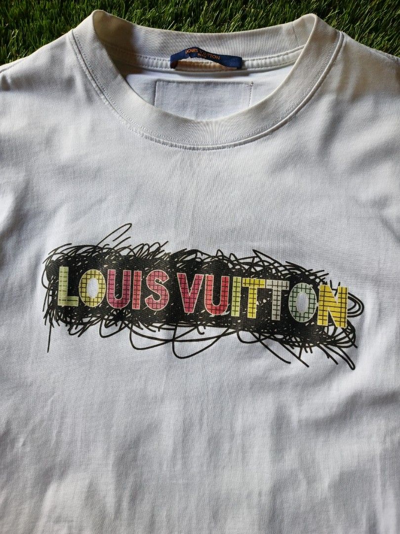 Louis Vuitton T-shirt (Category: Tshirts & Polo Shirts ) located in Dipolog. Submitted by vinzz_thrift (Listing ID 1461690837, Image 2). Description: - Authentic Louis Vuitton t-shirt - Color: White - Design: LV logo with colorful scribble - Size: XS - Ideal for casual outings.