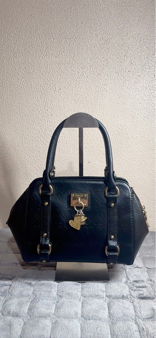 LOVCAT Paris Black Leather Heart Embossed Handbag (Category: Shoulder Bags) located in Quezon City. Submitted by donnabelle7572 (Listing ID 1461783417, Image 1). Description: - Brand: Authentic LOVCAT Paris - Material: Black Leather - Top handle bag - Length: 10" or 26cm -Width: 4.5" or 11cm -Height: 7" or 17.3cm -Manage your expectations since it is a preloved bag. -Gold hardware with fadings 7/10 -Bawal po sa sobrang selan.
