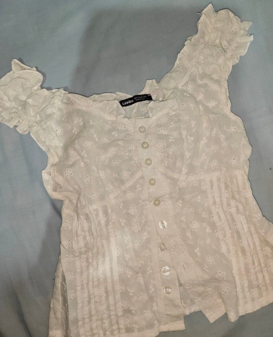 Lovito White Eyelet Ruffle Off-Shoulder Top (Category: Blouses) located in Quezon. Submitted by strawberry_me (Listing ID 1461668523, Image 2). Description: - Cute white top from Lovito - Features eyelet details - Ruffles along neckline and sleeves - Button-up front - Pairs well with jeans or skirts - Perfect for casual outings or a summer vibe ‼️ STRICTLY: • No cancellation of orders • No return, no refund • No bogus buyers 💸 MODE OF PAYMENT: G