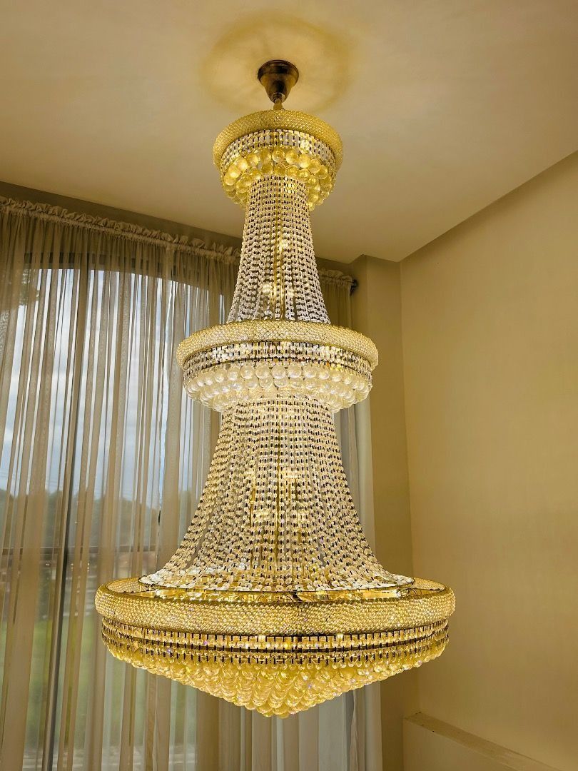 Luxury Crystal Chandelier (Category: Lighting) located in Davao. Submitted by emmabasoc (Listing ID 1461582952, Image 1). Description: - Beautiful multi-tiered chandelier - Features sparkling crystals and elegant gold accents - Creates a grand and luxurious atmosphere - Ideal for dining rooms or living areas - Illuminates your space beautifully - Ready for installation.