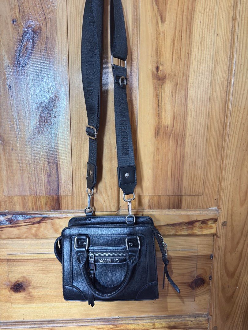 Madden NYC Black Mini Top Handle Bag with Strap (Category: Luxury Bags & Wallets) located in Baguio. Submitted by declutterbycys (Listing ID 1461584112, Image 3). Description: - Cute black mini bag from Madden NYC - Features a top handle - Includes a detachable crossbody strap - Front zipper pocket for easy access - Small size, ideal for carrying essentials - Versatile, pairs well with casual outfits.