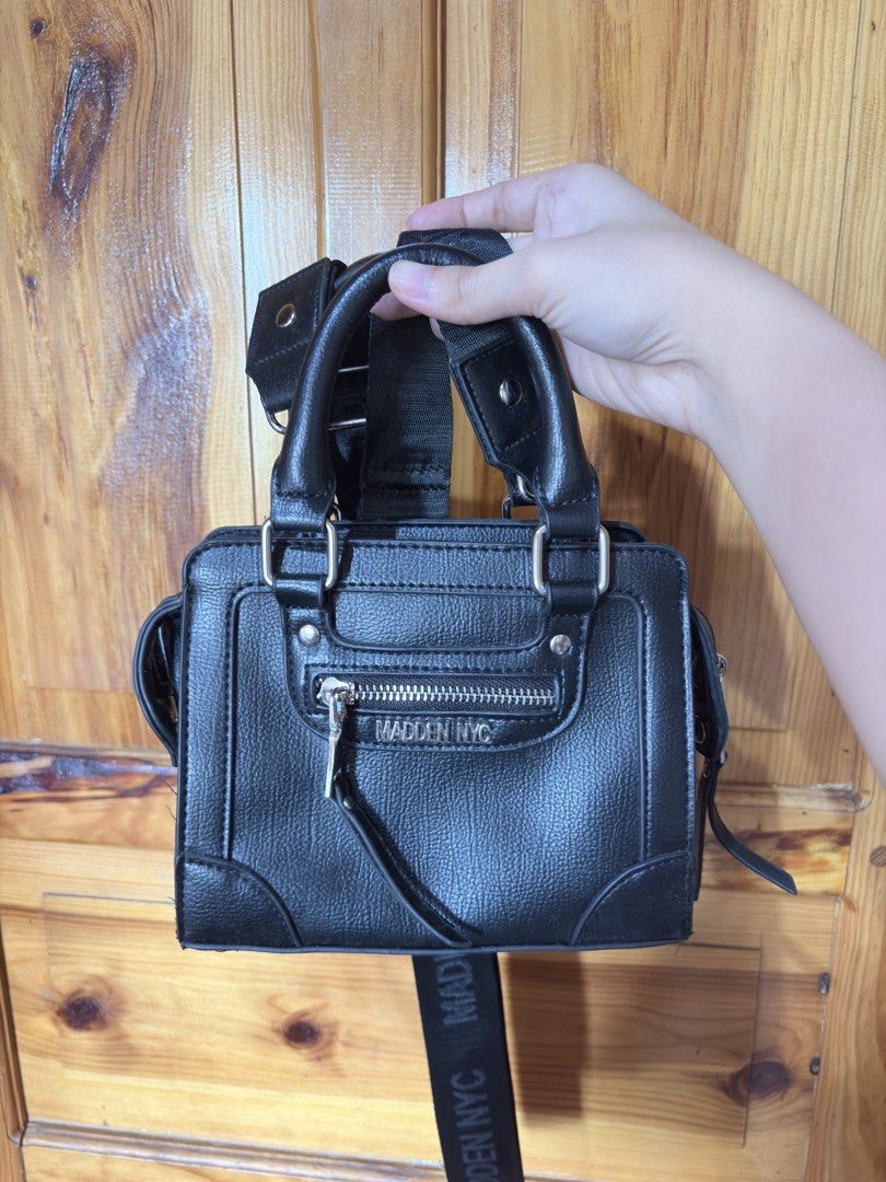 Madden NYC Black Mini Top Handle Bag with Strap (Category: Luxury Bags & Wallets) located in Baguio. Submitted by declutterbycys (Listing ID 1461584112, Image 2). Description: - Cute black mini bag from Madden NYC - Features a top handle - Includes a detachable crossbody strap - Front zipper pocket for easy access - Small size, ideal for carrying essentials - Versatile, pairs well with casual outfits.