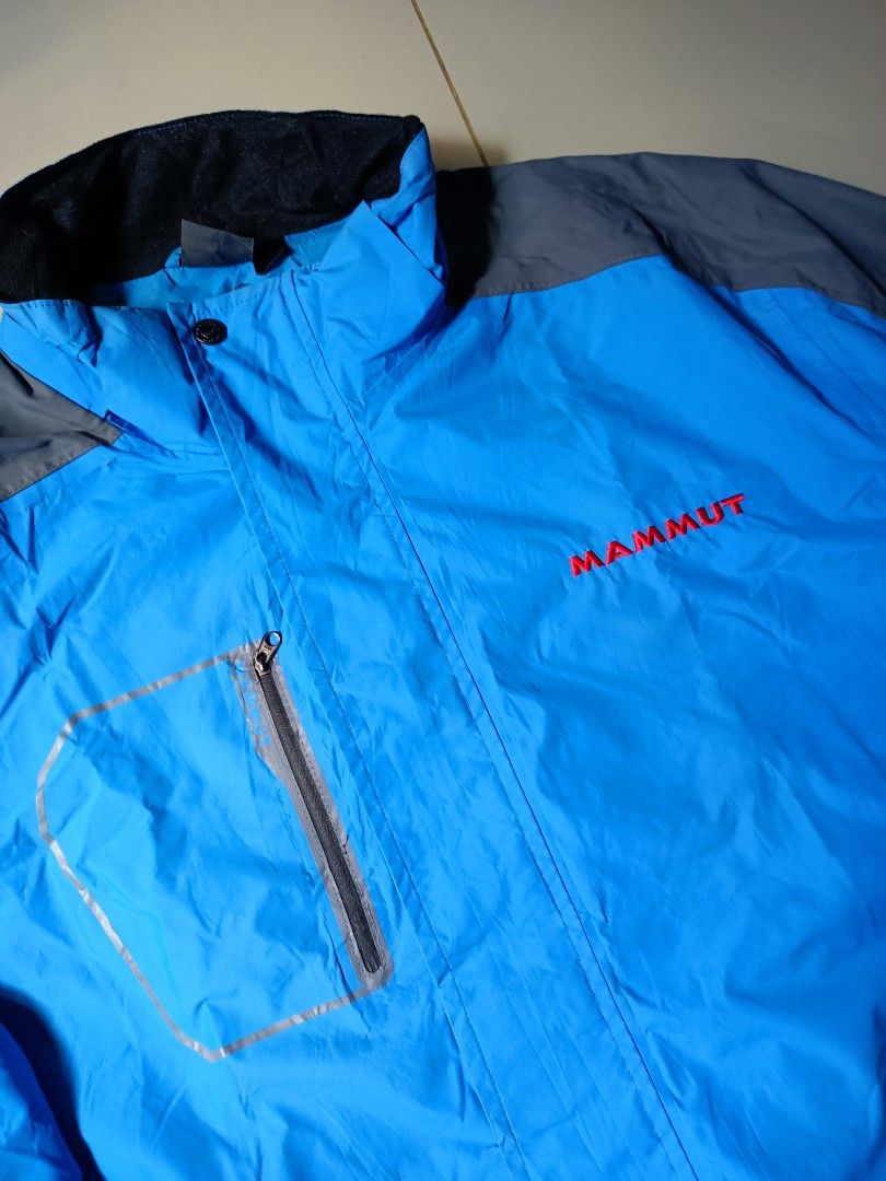 Mammut Blue & Grey Outdoor Jacket (Category: Coats, Jackets and Outerwear) located in Manila. Submitted by pnjdianne25879 (Listing ID 1461645604, Image 2). Description: 24 x 29 - Brand: Mammut - Color: Blue and Grey - Features: Chest zip pocket, adjustable hem, hood - Closure: Zipper - Branding: Mammut logo on chest and sleeve - Ideal for: Outdoor activities.