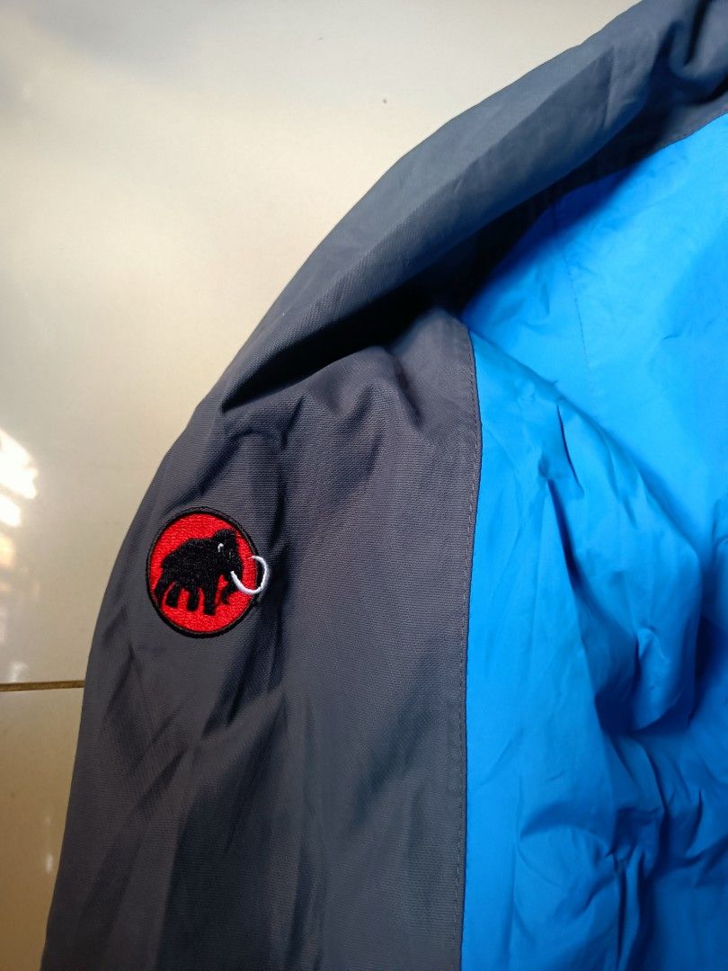 Mammut Blue & Grey Outdoor Jacket (Category: Coats, Jackets and Outerwear) located in Manila. Submitted by pnjdianne25879 (Listing ID 1461645604, Image 3). Description: 24 x 29 - Brand: Mammut - Color: Blue and Grey - Features: Chest zip pocket, adjustable hem, hood - Closure: Zipper - Branding: Mammut logo on chest and sleeve - Ideal for: Outdoor activities.