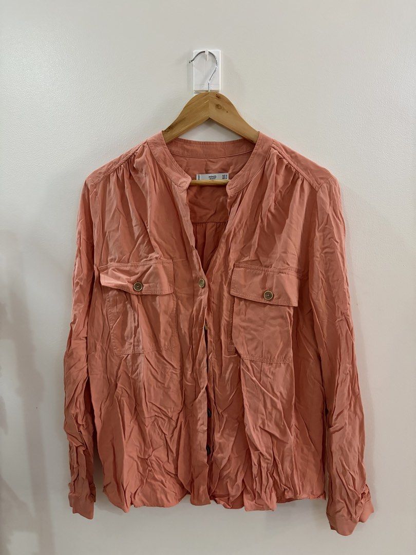 Mango Basics Salmon Colored Long Sleeve Polo/Button-Up Shirt (Category: Shirts) located in San Juan City. Submitted by sel.ler (Listing ID 1461676828, Image 1). Description: - Orange/Salmon MNG Basics shirt - Button-up front - Two chest pockets - Band collar neckline - Made in Vietnam - Size M (EUR) - Relaxed fit - Ideal for casual wear.