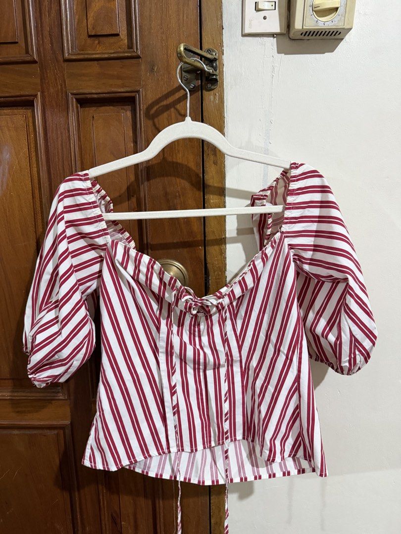 Mango red and white stripe puff sleeve corset top (Category: Blouses) located in Quezon City. Submitted by latiendadejaye (Listing ID 1461624171, Image 1). Description: Purchased from Mango store US Size M Worn a few times, some fraying on the inner part of the top and some yellowing on the garter at the back MOP: BPI, Gcash, Maya RFS: cleaning out my closet.