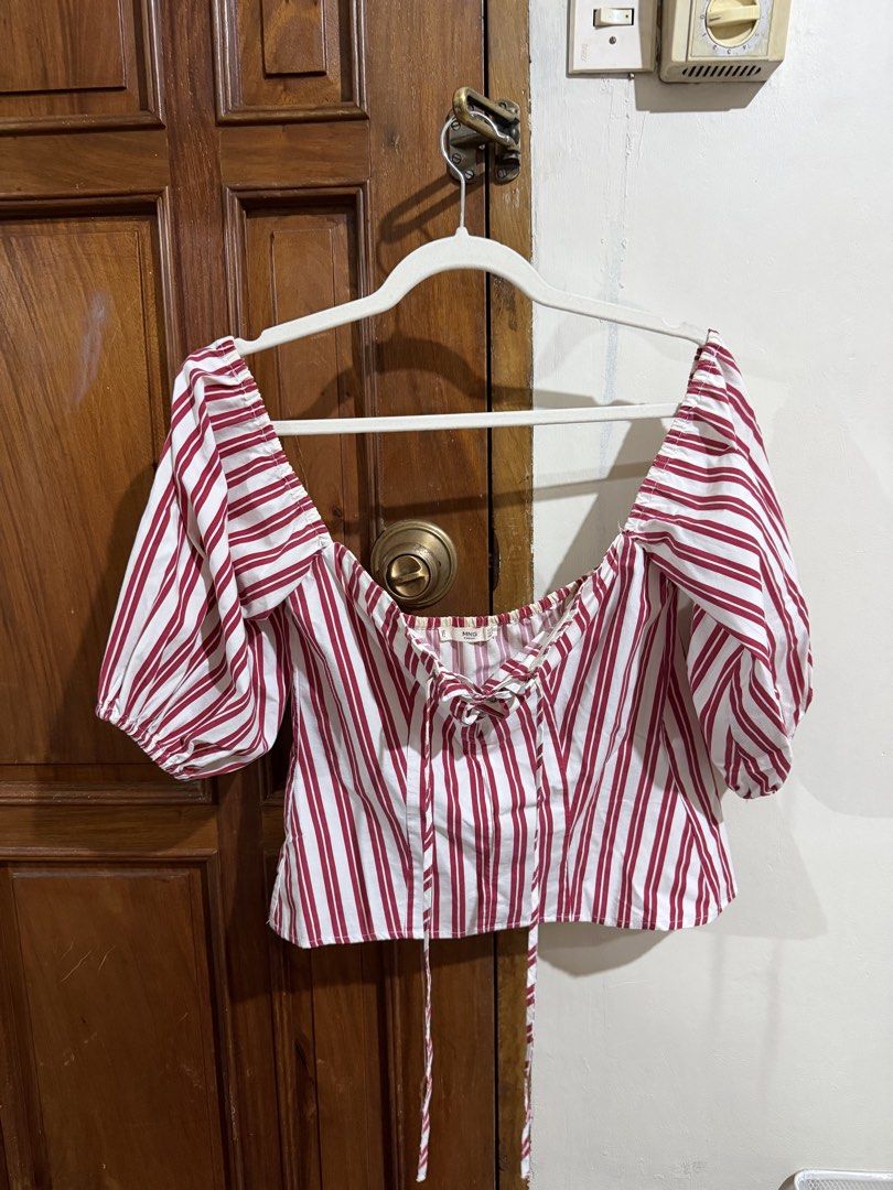 Mango red and white stripe puff sleeve corset top (Category: Blouses) located in Quezon City. Submitted by latiendadejaye (Listing ID 1461624171, Image 2). Description: Purchased from Mango store US Size M Worn a few times, some fraying on the inner part of the top and some yellowing on the garter at the back MOP: BPI, Gcash, Maya RFS: cleaning out my closet.