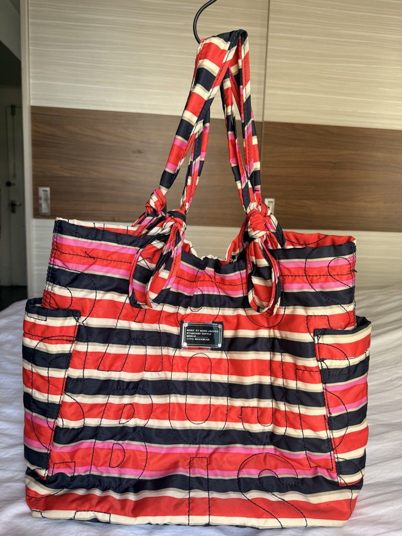 Marc by Marc Jacobs Standard Supply Tote Reversible Bag (Category: Tote Bags) located in Taguig. Submitted by _annaq_ (Listing ID 1461658810, Image 1). Description: - Authentic Marc by Marc Jacobs tote bag - Reversible design: striped pattern on one side, bold logo on the other - Spacious interior for all your essentials - Unique knotted handle detail - Ideal for everyday use, shopping, or travel - Please check photos for condition and details Fo