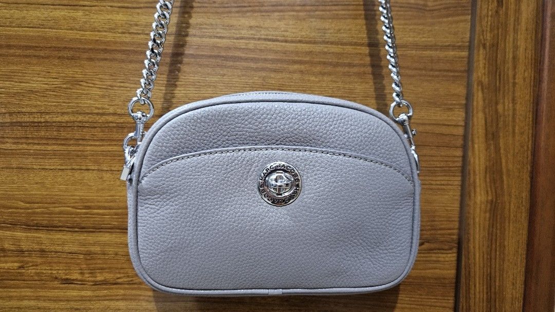 Marc Jacobs Leather Crossbody Bag (Category: Luxury Bags & Wallets) located in Quezon City. Submitted by gabrielscloset (Listing ID 1461650820, Image 2). Description: - Authentic Marc Jacobs grey leather crossbody bag - Features a stylish silver chain strap - Signature Marc Jacobs logo on the front - Comes with original tags and authenticity card - Versatile for everyday use or evening events Bag Dimensions & Size Width (Length): 8.5 inches (appr
