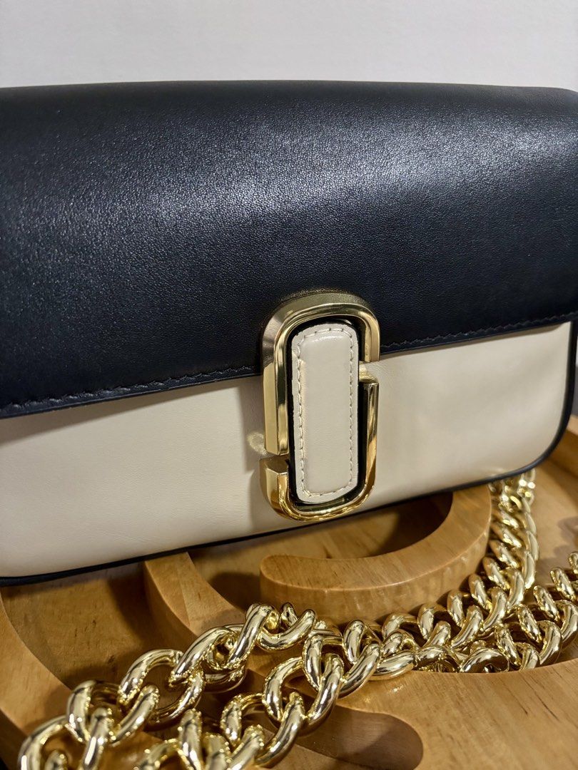 Marc Jacobs Shoulder Bag (Category: Luxury Bags & Wallets) located in Makati City. Submitted by andylooney (Listing ID 1461793784, Image 3). Description: Authentic Marc Jacobs bag Color - Greige multi * Adjustable chain and webbing strap, gold-tone designer logo, back slip pocket * Interior slip pocket, zip pocket * Snap-fastening front flap * Dimensions: H: 16cm x W: 25cm x D: 5cm. Handle Drop: 27cm. Strap Drop: 68cm. * Box, dust bag, bag tags i