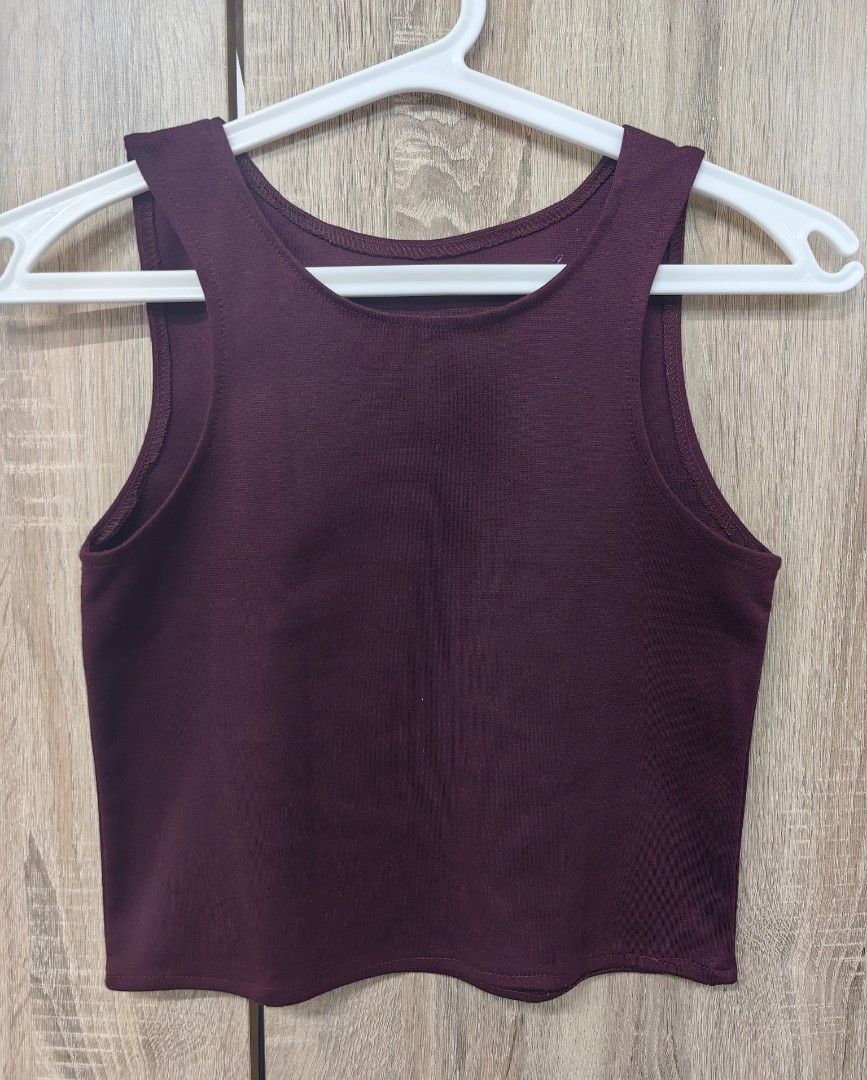 Maroon Sleeveless Crop Top (Category: Sleeveless) located in Las Pinas. Submitted by offtonewhome (Listing ID 1461564864, Image 1). Description: - Deep maroon sleeveless crop top - Ribbed fabric texture - Simple, classic cut - Versatile for layering or wearing on its own - Effortlessly pairs with jeans or skirts - Comfortable and easy to style.