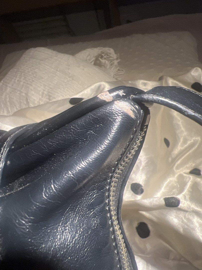 Matin Kim grunge shoulder bag black (Category: Shoulder Bags) located in Bacolod City. Submitted by mae.ll (Listing ID 1461671035, Image 3). Description: - Black handbag - Shows wear on corners - Zipper closure is intact - Suitable for everyday use, with minor cosmetic imperfections.
