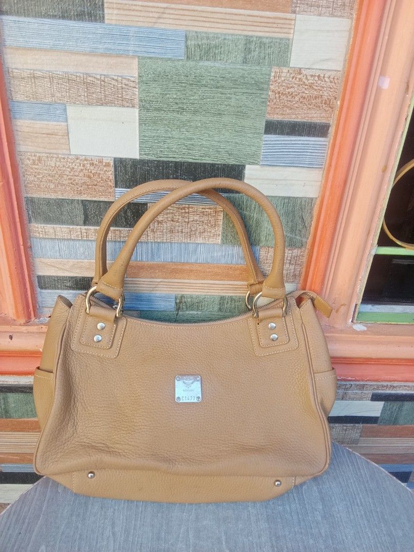 MCM München Leather Shoulder Bag (Category: Shoulder Bags) located in Bacoor. Submitted by aileen678s75866 (Listing ID 1461797619, Image 1). Description: - MCM tan leather shoulder bag - Features classic MCM logo plate and hardware - Spacious interior, perfect for everyday essentials.