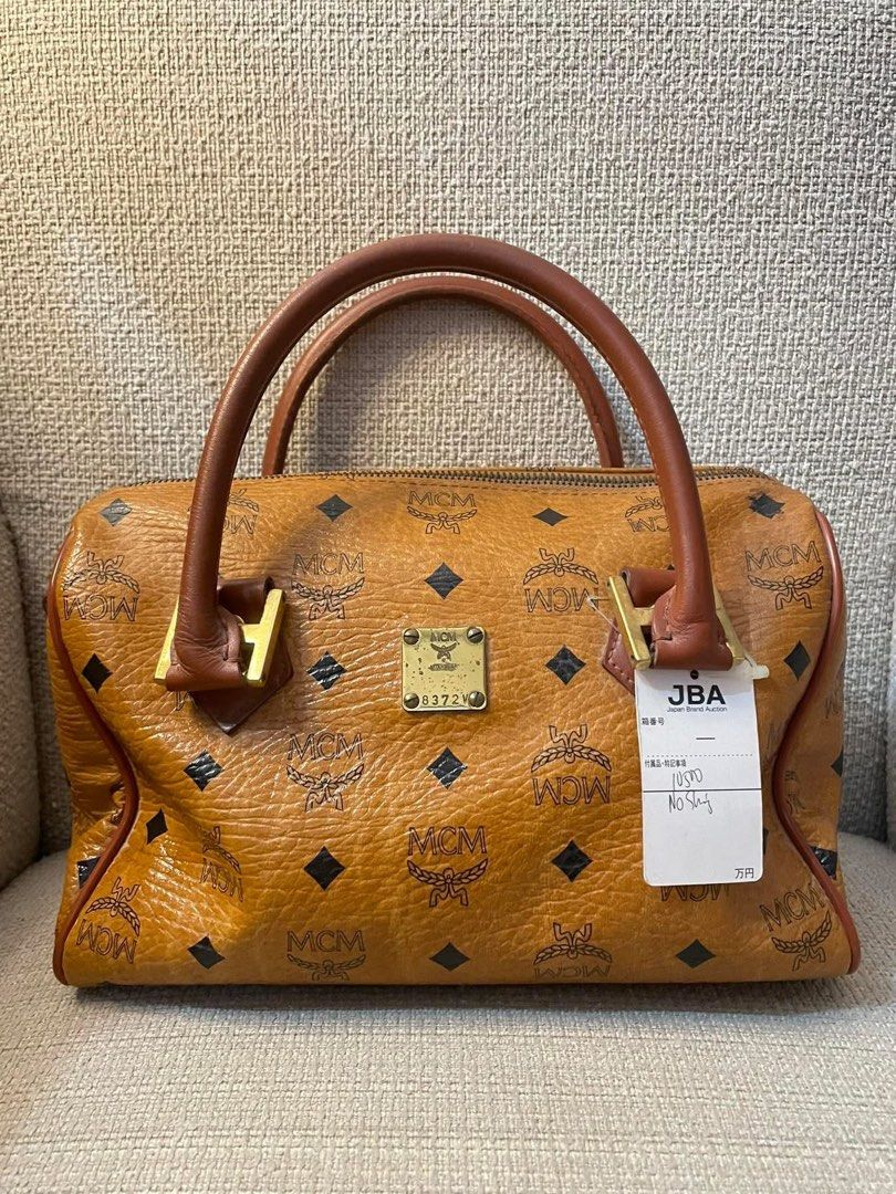 MCM Visetos Boston Bag (Category: Luxury Bags & Wallets) located in Quezon City. Submitted by hadescloset (Listing ID 1461727591, Image 1). Description: - Classic MCM Boston bag - Authentic Japanese Auction - Signature Visetos print - Tan leather handles and trim - Gold-tone hardware - Features serial number plate and JBA tag - Ideal for everyday use or travel - Spacious interior.