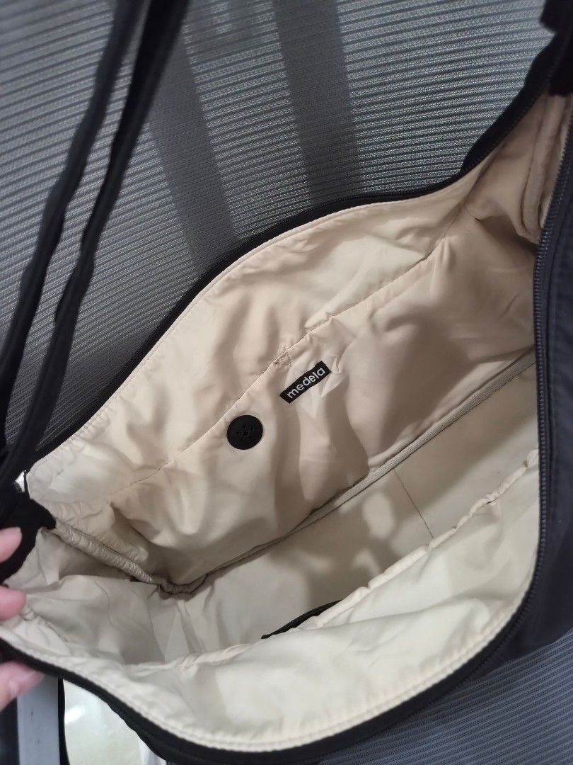 Medela Breastpump Bag (Category: Shoulder Bags) located in Koronadal. Submitted by shineubs (Listing ID 1461611349, Image 2). Description: - Sleek black nylon breastpump bag - extra bag rarely used - Adjustable strap for comfortable wear - Exterior: Front zippered pocket and side flap pocket - Interior: Small zippered pocket - Elegant silver hardware details - Clean and minimalist design, perfect for breastfeeding mom .