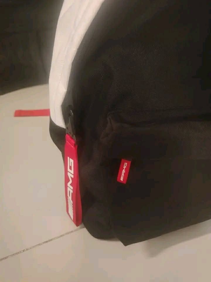 Mercedes-Benz AMG Backpack Black White Red (Category: Backpacks) located in Manila. Submitted by wildwind_73f77a (Listing ID 1461640254, Image 3). Description: - Black and white backpack with striking red accents. - Features the iconic AMG logo on the front. - Comes with a cool red keychain. - Adjustable red straps for a comfortable fit. - Spacious interior for all your essentials. - Ideal for everyday use or your next adventure..