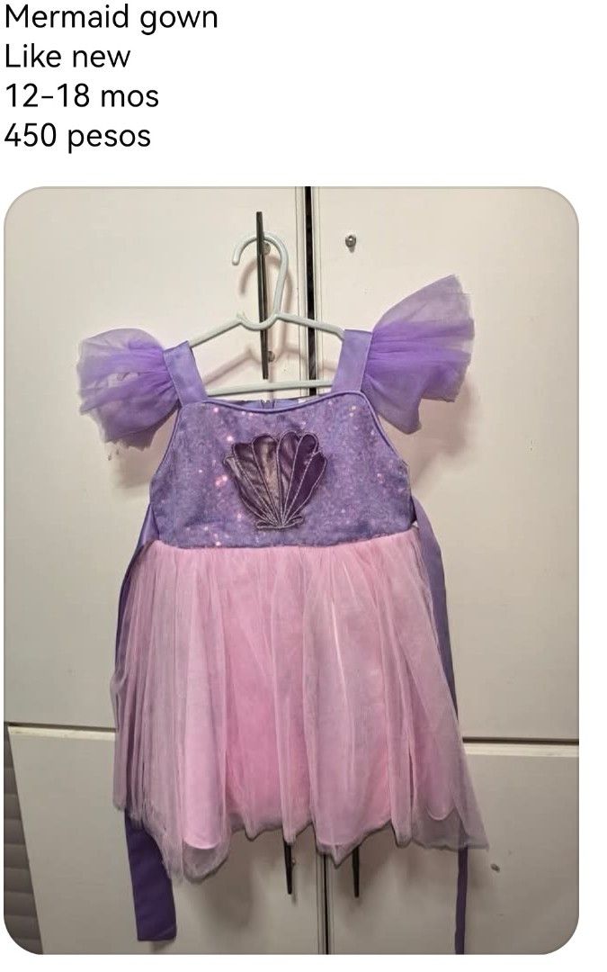 Mermaid Gown for 12-18 Months (Category: Babies & Kids Fashion) located in Cabanatuan. Submitted by saffy17 (Listing ID 1461583659, Image 1). Description: - Cute mermaid gown for babies aged 12-18 months. - Sparkly purple top with a charming shell detail. - Flowy pink and purple skirt for a magical look. - Features delicate, sheer puffy sleeves. - Ideal for parties, special occasions, or imaginative dress-up play..