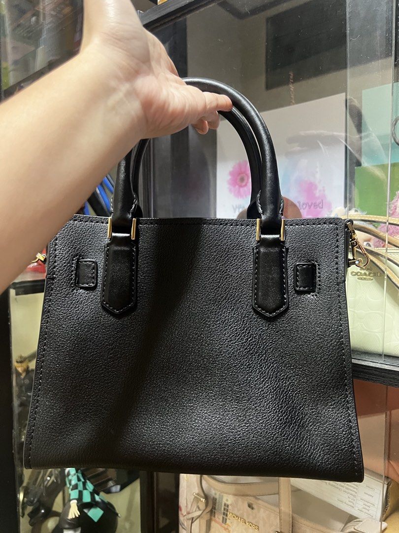 Michael Kors Black Leather Hamilton (Category: Shoulder Bags) located in Caloocan City. Submitted by ericavi_g (Listing ID 1461601593, Image 2). Description: - Authentic Michael Kors black leather satchel bag - Elegant gold hardware, featuring the signature lock and key charm - Versatile carrying options with top handles and a detachable strap - Luxurious pebbled leather texture - Ample interior space for all your essentials - Ideal for both dail