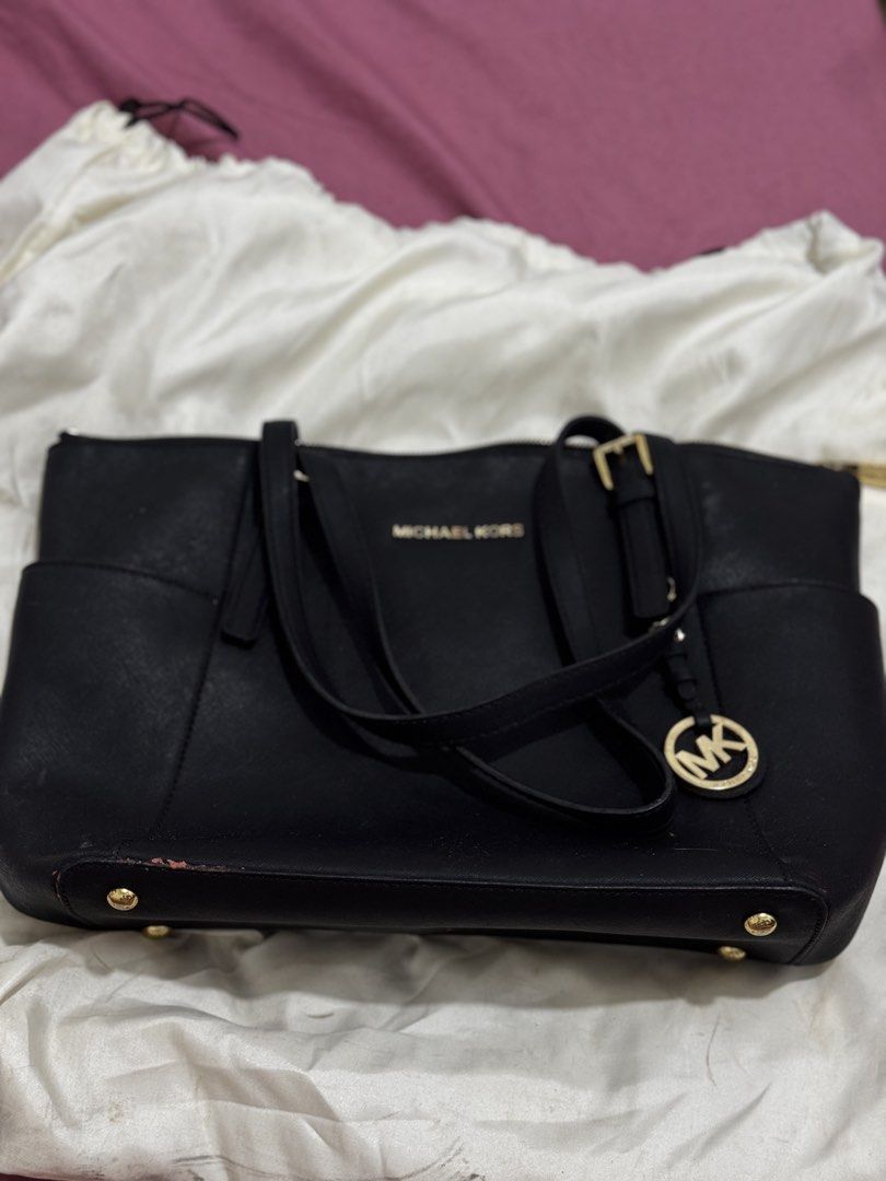 Michael Kors Black Leather Tote Bag (Category: Tote Bags) located in Bauang. Submitted by jeneefromtheblock (Listing ID 1461774505, Image 1). Description: - Original Black Michael Kors tote bag - Genuine leather material - Elegant gold hardware details - Convenient exterior side pockets - Spacious interior with multiple compartments - Signs of wear on bottom corners and some marks on the front - Comes with original dust bag - Ideal everyday bag.