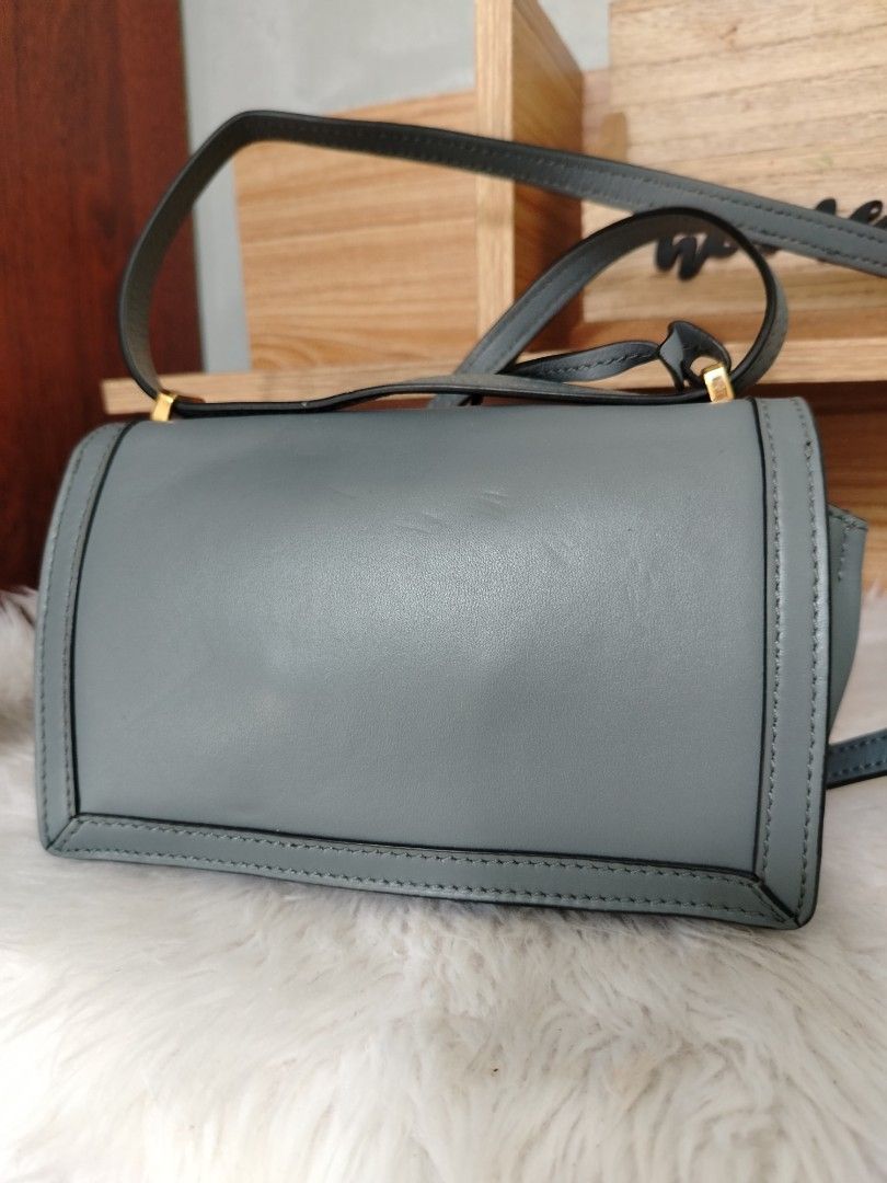 MINI BARCELONA (Category: Luxury Bags & Wallets) located in Lucena. Submitted by gracious_chin0436 (Listing ID 1461569642, Image 2). Description: - Size: Small - Color: Dusty Blue - Material: Genuine Leather - Hardware: Gold - Features: Adjustable strap - Versatile: Ideal for everyday or special occasions with minimal sign of used on metal near brand name scratch and pressed mark inside due to storage which cause code and MADE IN slight invissibl