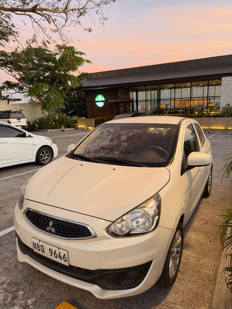Mitsubishi Attrage Mirage Hatchback Auto (Category: Used Cars) located in Quezon City. Submitted by chriscuenca06 (Listing ID 1461669037, Image 2). Description: For Sale: Mitsubishi Mirage Hatchback GLX 2018 - Acquired March 2019. Pearl White 1.2L 3A92 Mivec Gas Engine. Casa Maintained from Day 1. Complete Casa Record via Casa Booklet. Manual included Registered Till June 2027 - Ako po owner and seller Upgrades and Maintenance: Thick Tires G4 15’