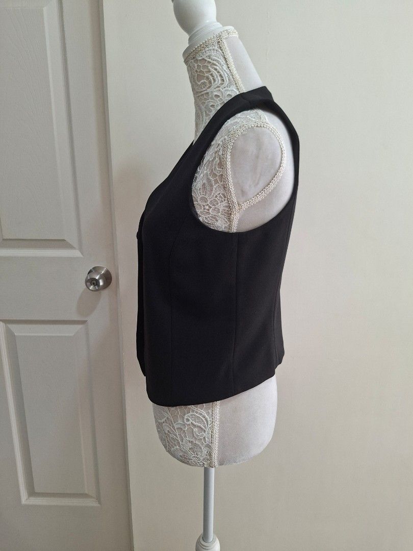 MNG Black Sleeveless Vest Size M (Category: Sleeveless) located in Pasig City. Submitted by avcan (Listing ID 1461576796, Image 2). Description: - MNG black sleeveless vest - Button-up front with 3 buttons - Made in Vietnam - Ideal for layering over shirts or dresses - Versatile for smart casual or formal looks - Please check photos for condition details - Note that one button at the bottom is not attached, but I pinned it to the washtag (DIY sew