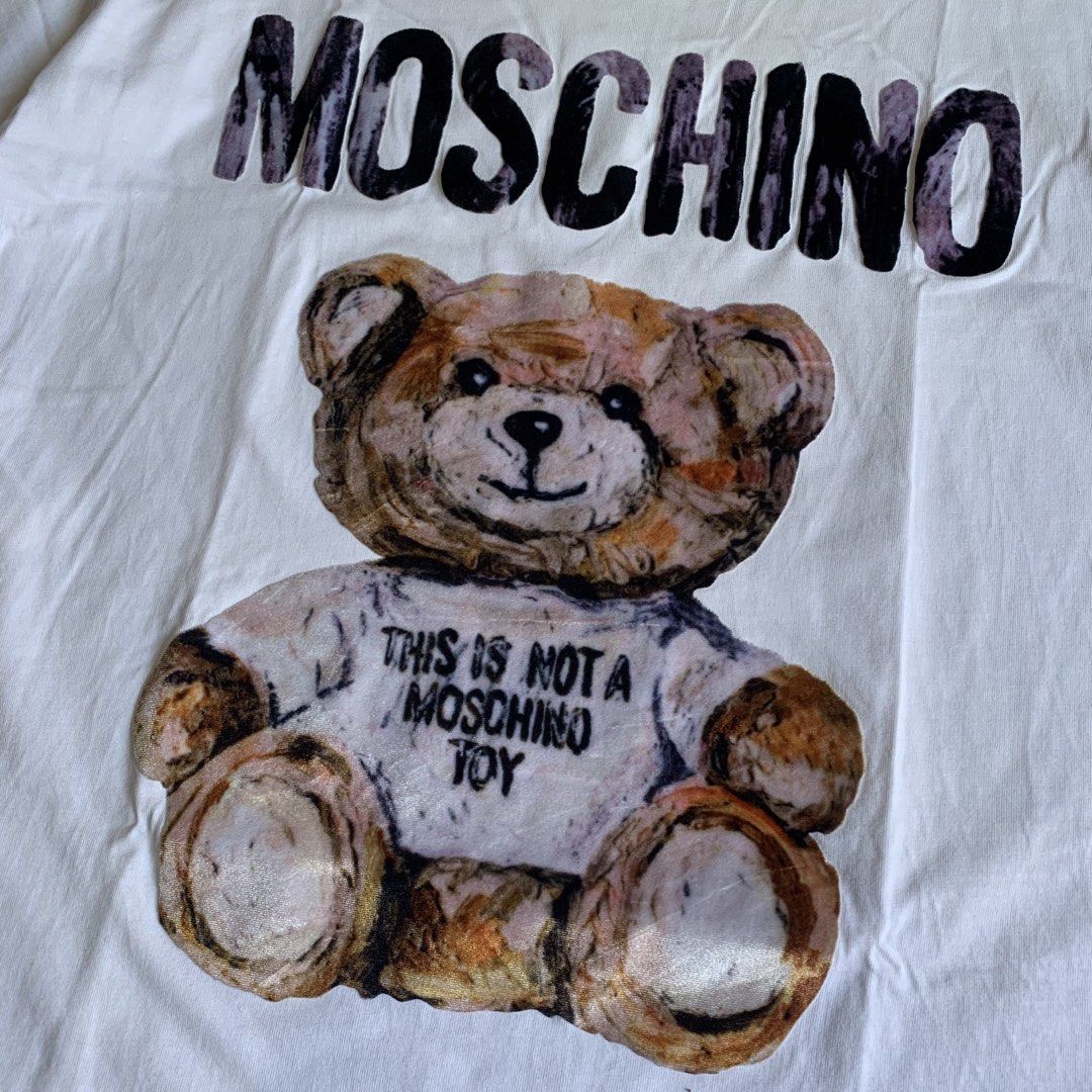 MOSCHINO Teddy Bear T-Shirt White (Category: Activewear) located in Manila. Submitted by emplysthrift. (Listing ID 1461729169, Image 3). Description: Moschino Couture Teddy Bear Graphic Tshirt Width "20.5 Length "27 Excellent Condition Colorrate: 9.3/10 Flaws: none Unli vouchers/vc for safe transactions 📲 Location: Laspinas City, Metro Manila, Brngy Talon Uno. 📍 DM IF INTERESTED📥 - Iconic Moschino Teddy Bear graphic - "This is not a Moschino T