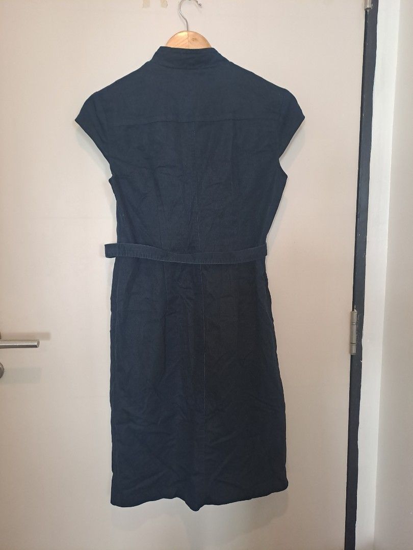 Navy blue dress (Category: Dresses) located in Manila. Submitted by joanbalde39643 (Listing ID 1461589010, Image 3). Description: The image shows a Connected Apparel dark navy blue cap-sleeve sheath dress featuring a distinctive leopard print inner lining. It is constructed from a stretch fabric and is designed with button accents down the front..