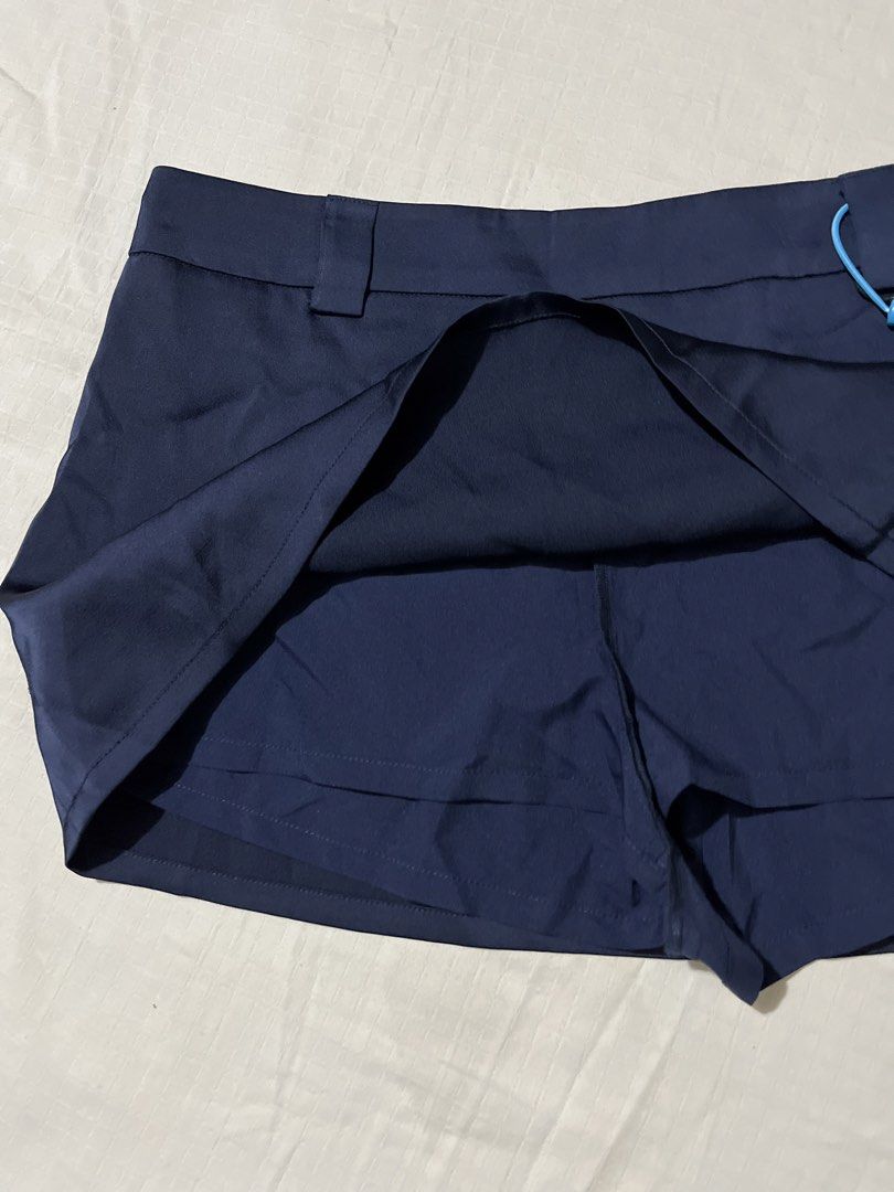 Navy Blue Mini Skirt with Inner Shorts (Category: Skirts) located in Quezon City. Submitted by earthtodior (Listing ID 1461795551, Image 3). Description: - Navy blue mini skirt - XS to Small - Bright blue side drawstring detail - Fabric has a slight sheen - Ideal for casual outfits.