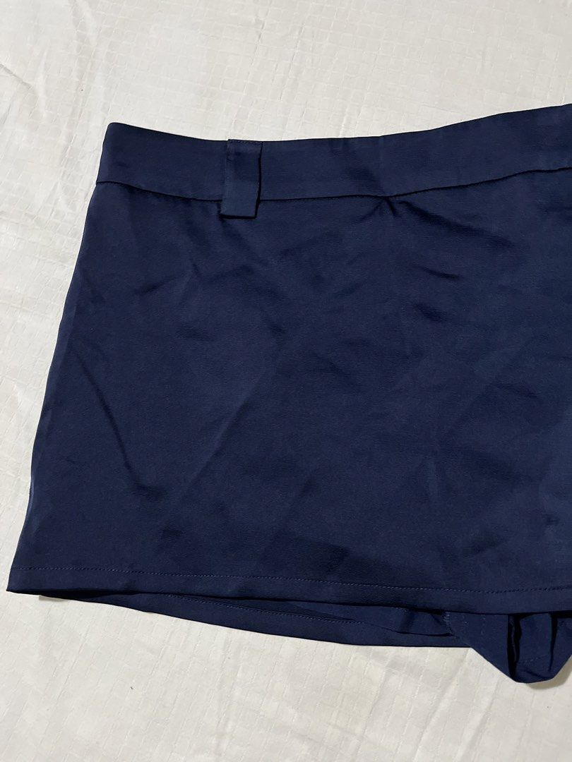Navy Blue Mini Skirt with Inner Shorts (Category: Skirts) located in Quezon City. Submitted by earthtodior (Listing ID 1461795551, Image 2). Description: - Navy blue mini skirt - XS to Small - Bright blue side drawstring detail - Fabric has a slight sheen - Ideal for casual outfits.