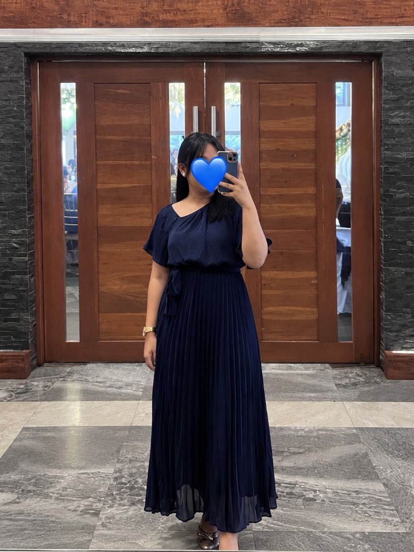 Navy Blue Pleated Midi Dress with One-Shoulder Design (Category: Dresses) located in Makati City. Submitted by aesthethings_ph (Listing ID 1461717607, Image 1). Description: - Navy blue midi dress - Pleated skirt - One-shoulder neckline - Includes tie belt for waist cinching - Flutter sleeves - Ideal for events or a night out - Comfortable and flowy material.