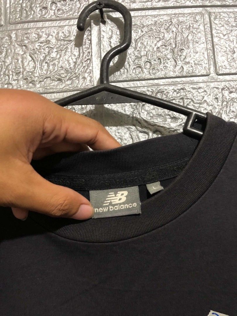 New Balance Shirt (Category: Earphones) located in Manila. Submitted by wildshark-33d3 (Listing ID 1461769868, Image 3). Description: Authentic Good condition issue check last picture / minimal hairline logo sa back print.