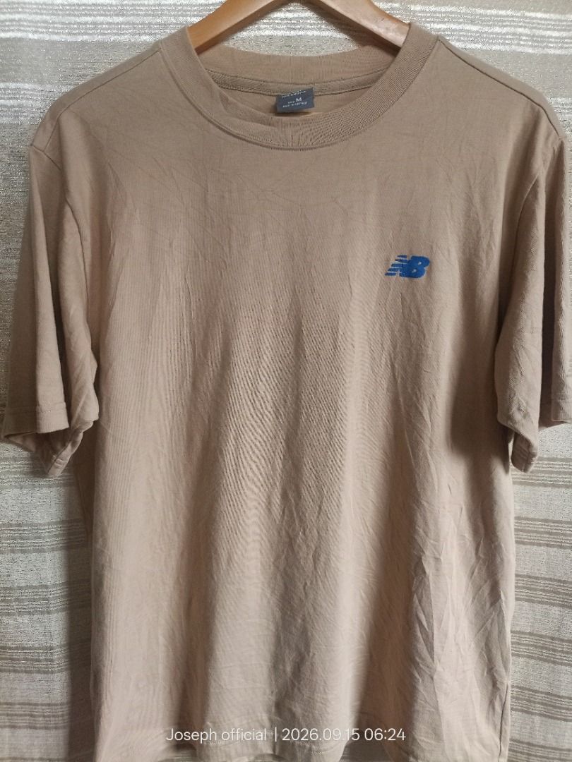 New Balance T-Shirt Size M (Category: Shirts) located in Caloocan City. Submitted by kingjose_16 (Listing ID 1461794129, Image 1). Description: - Brand New Balance T-shirt - Size: Medium (M) - Design: Small blue NB logo on chest - Back Graphic: Person cycling with 'Ride with your rhythm' text - Origin: Made in Vietnam.