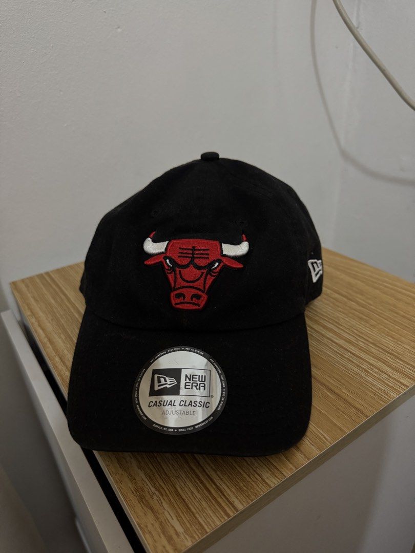 New Era Chicago Bulls Casual Classic Adjustable Cap (Category: Caps & Hats) located in Bulacan. Submitted by alshopie (Listing ID 1461629324, Image 1). Description: - Brand New Era Cap - Color: Black - Team: Chicago Bulls - Style: Classic, Casual - Feature: Adjustable strap - Perfect for any Bulls fan - Easy to wear and style.