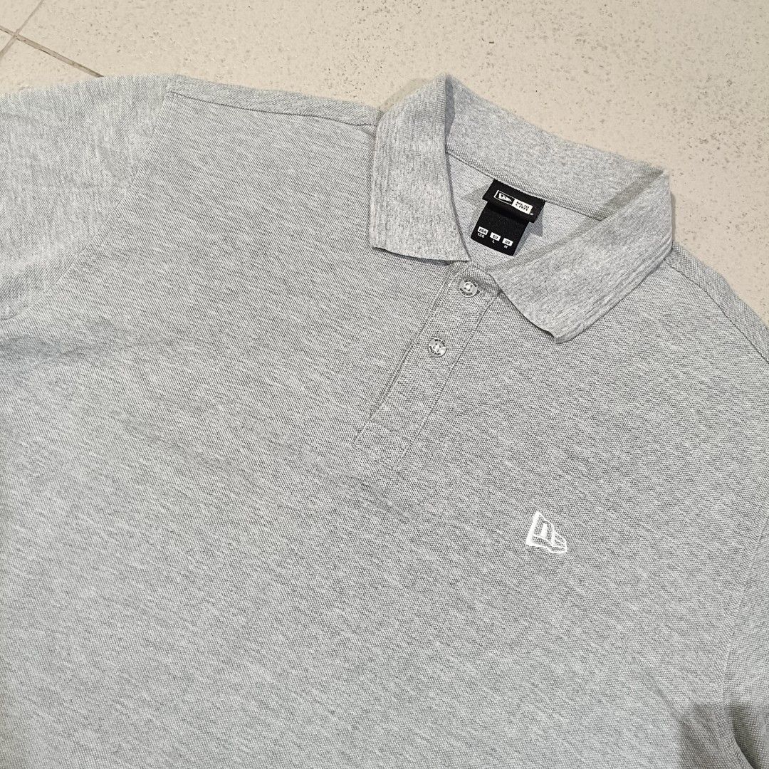 New Era Polo Shirt (Category: Tshirts & Polo Shirts ) located in Cebu City. Submitted by findwaze6000 (Listing ID 1461755749, Image 2). Description: EXCELLENT TO NEW❗ SIZE LARGE ON TAG WIDTH: 21.5 LENGTH: 27.5 BACK 28.5 NO ISSUE COLOR: GREY EMBROIDERY LOGO ✅ MATERIAL: 53% COTTON / 47% POLYESTER LOCATION: CEBU CITY📍.