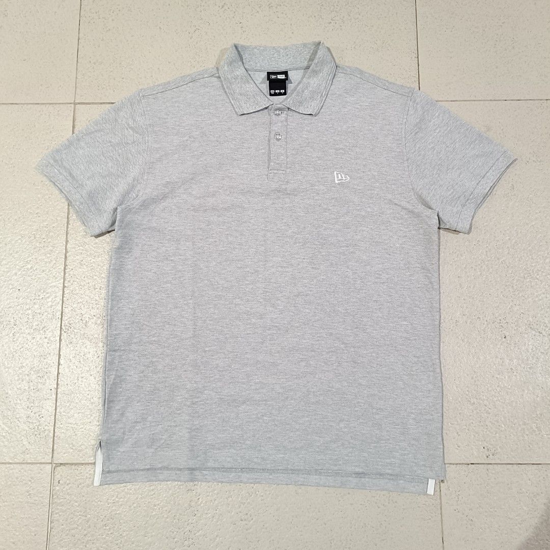 New Era Polo Shirt (Category: Tshirts & Polo Shirts ) located in Cebu City. Submitted by findwaze6000 (Listing ID 1461755749, Image 1). Description: EXCELLENT TO NEW❗ SIZE LARGE ON TAG WIDTH: 21.5 LENGTH: 27.5 BACK 28.5 NO ISSUE COLOR: GREY EMBROIDERY LOGO ✅ MATERIAL: 53% COTTON / 47% POLYESTER LOCATION: CEBU CITY📍.