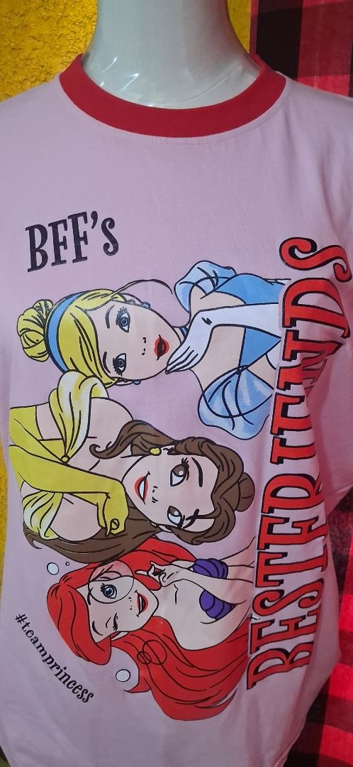 Newmily Studio Disney Princess BFF's Ringer Tee (Category: Shirts) located in Manila. Submitted by katkween23 (Listing ID 1461607086, Image 3). Description: - Adorable pink ringer t-shirt - Features Disney Princesses Ariel, Belle, and Cinderella - Text reads 'BFF's Bestfriends' and '#teamprincess' - Contrasting red collar and sleeve trim - Made in Thailand by Newmily Studio - Ideal for Disney enthusiasts and best friends.