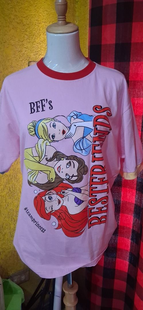 Newmily Studio Disney Princess BFF's Ringer Tee (Category: Shirts) located in Manila. Submitted by katkween23 (Listing ID 1461607086, Image 2). Description: - Adorable pink ringer t-shirt - Features Disney Princesses Ariel, Belle, and Cinderella - Text reads 'BFF's Bestfriends' and '#teamprincess' - Contrasting red collar and sleeve trim - Made in Thailand by Newmily Studio - Ideal for Disney enthusiasts and best friends.