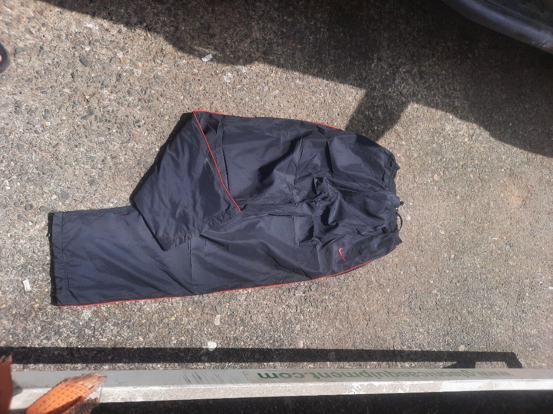 Nike Black Track Pants with Red Stripe (Category: Joggers) located in Manila. Submitted by juan.thehustler (Listing ID 1461677180, Image 3). Description: - Black Nike track pants - Features a red stripe down the side - Adjustable drawstring waist - Pockets included - Perfect for sports or casual wear - Ready for a new owner!.