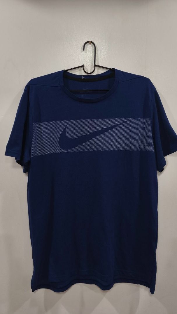 Nike bog swoosh (Category: Activewear) located in Quezon City. Submitted by secondtonone12 (Listing ID 1461706307, Image 1). Description: Brand: Nike Type: Men's short-sleeve athletic/performance T-shirt Color: Dark navy / College Navy Design: Large horizontal tonal/white pinstripe panel across the chest with an oversized Nike Swoosh.