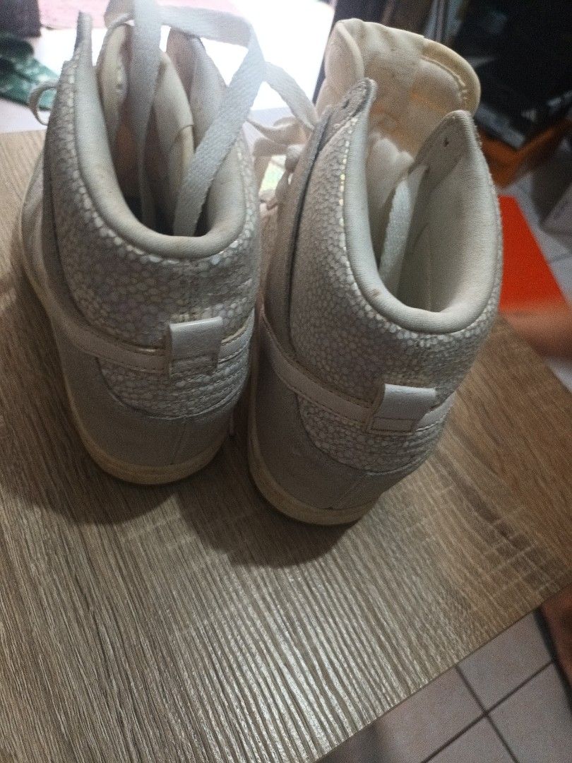 Nike Dunk High White Iridescent Sneakers (Category: Sneakers) located in Cainta. Submitted by ma_tres (Listing ID 1461594718, Image 3). Description: - White Nike Dunk Highs - Features an iridescent, textured overlay - Classic high-top silhouette - White laces - Gum brown soles - Pre-owned, but with plenty of life left - Perfect for everyday casual wear.