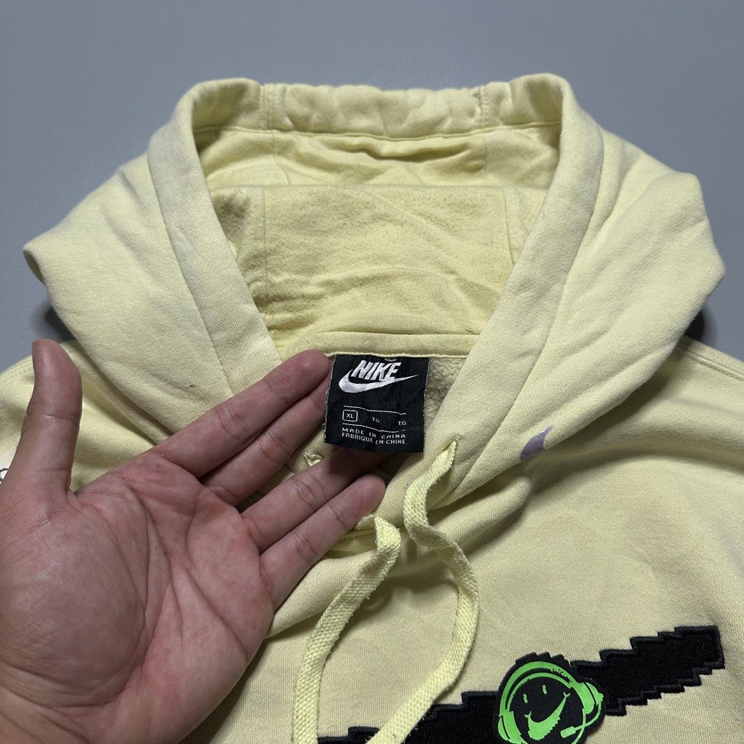 Nike Pixel Swoosh Hoodie Jacket (Category: Coats, Jackets and Outerwear) located in Baguio. Submitted by subaitems (Listing ID 1461628090, Image 3). Description: - Yellow Nike Hoodie - Size: XL - Pixelated Swoosh graphic - Kangaroo pocket - Drawstring hood.