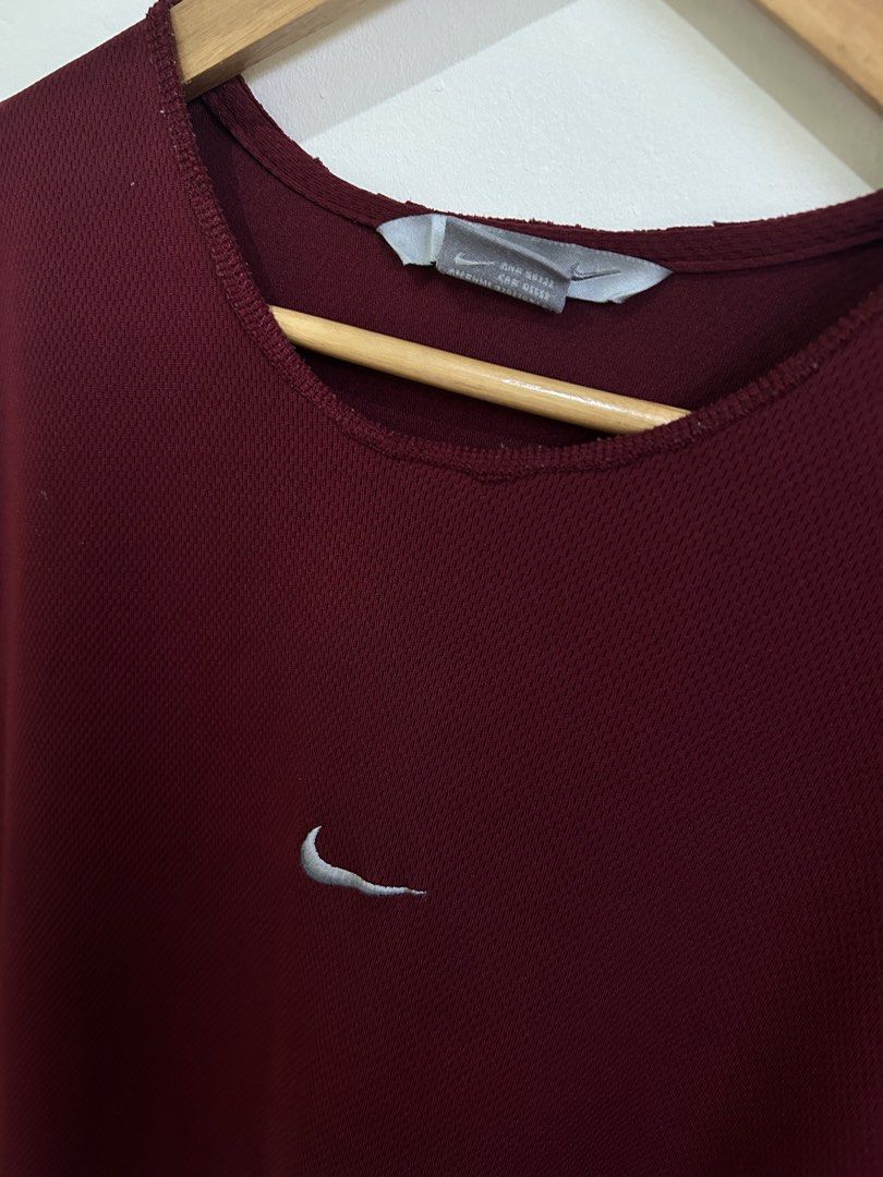 Nike Sleeveless Maroon Athletic Top (Category: Sleeveless) located in Angeles City. Submitted by johngamboa (Listing ID 1461597758, Image 2). Description: - Maroon Nike sleeveless top - Features iconic Nike swoosh logo - Contrasting grey and white side panels - Ideal for workouts and casual outings - Made with comfortable, breathable fabric.