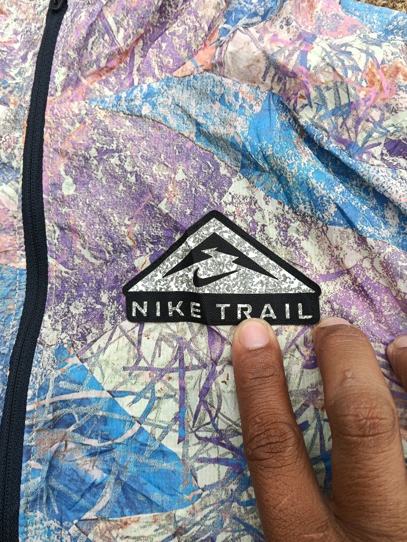 Nike Trail Shield Lightweight Hooded Jacket Size M (Category: Coats, Jackets and Outerwear) located in Malaybalay. Submitted by intingthrift (Listing ID 1461586628, Image 3). Description: - Lightweight Nike Trail jacket - Size: Medium - Cool abstract print (blue, pink, purple) - Full zip front with hood - Nike Shield technology for wind and water resistance - Ideal for running or hiking.