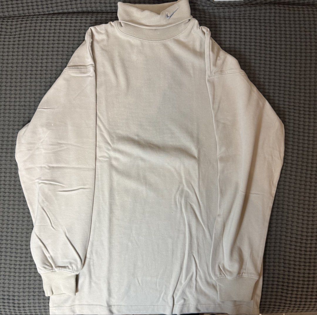 Nike Turtleneck Long Sleeve Shirt Beige (Category: Tshirts & Polo Shirts ) located in Manila. Submitted by kuyascloset (Listing ID 1461611936, Image 1). Description: - Classic beige Nike turtleneck long sleeve shirt. - Features a small embroidered Nike logo on the collar. - Versatile for layering or wearing solo. - Comfortable material for everyday use..
