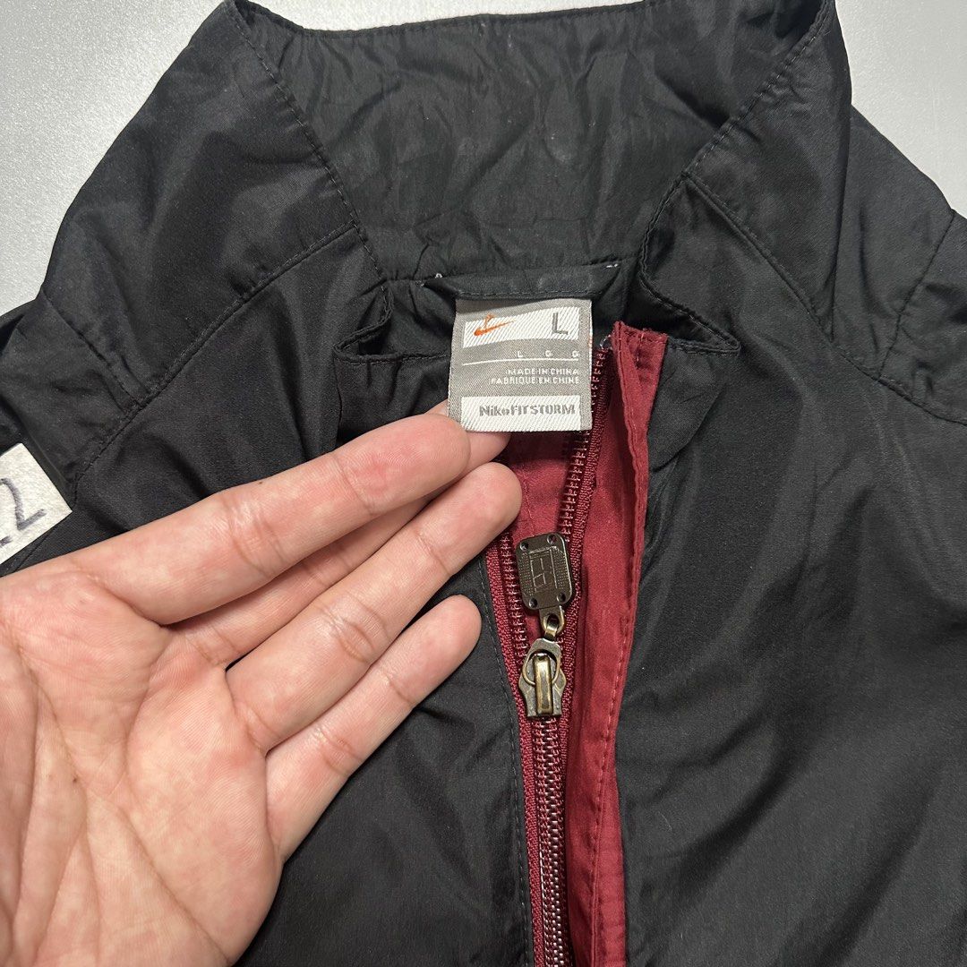 NIKE WINDBREAKER TRACK JACKET (Category: Coats, Jackets and Outerwear) located in Baguio. Submitted by subaitems (Listing ID 1461626813, Image 3). Description: - Classic Nike track jacket - Color: Black with maroon side panels - Features: Full zip front, stand-up collar, elasticated cuffs and hem - Technology: Nike Fit Storm - Size: L - Ideal for: Workouts or casual wear.