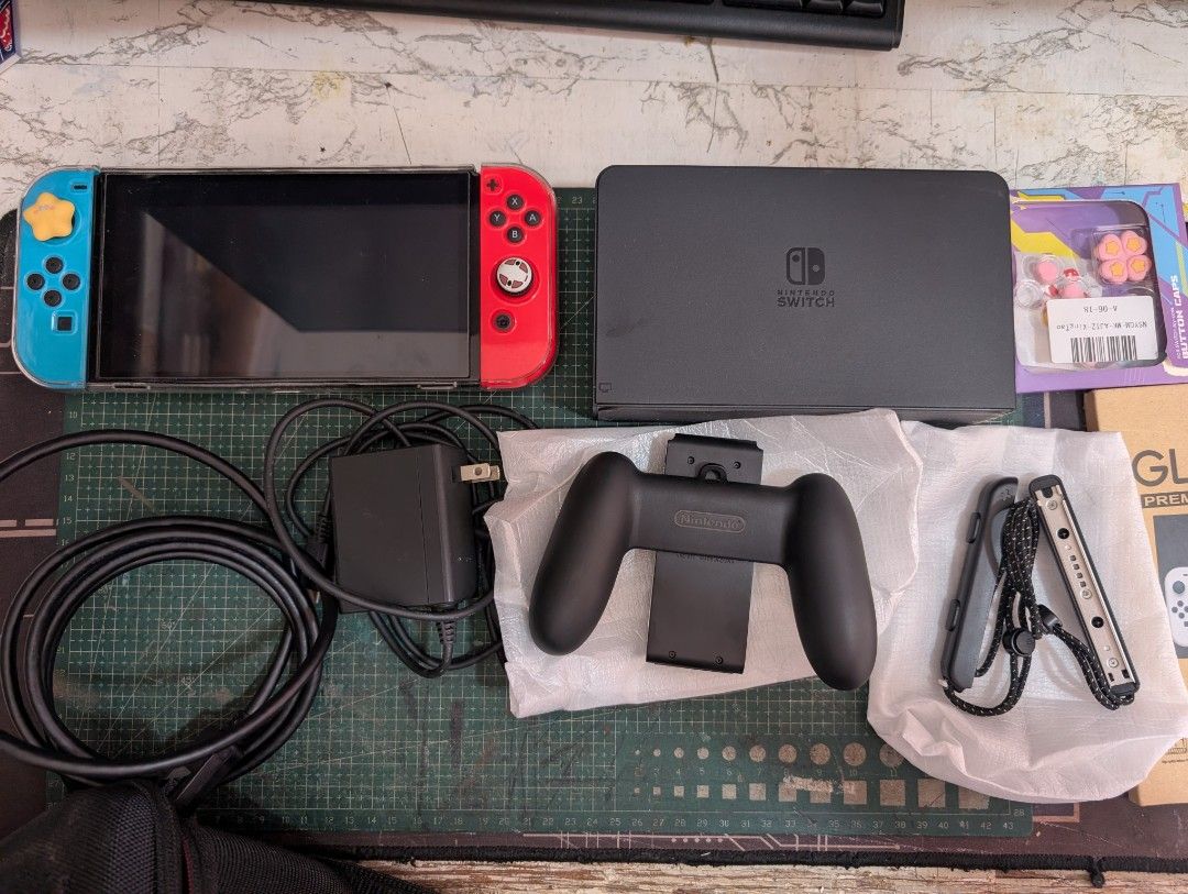 NINTENDO SWITCH OLED NEON RED NEON BLUE (Category: Nintendo) located in Manila. Submitted by chimarket01 (Listing ID 1459980785, Image 2). Description: ORIGINAL NINTENDO SWITCH NO ISSUES ✅ Original dock ✅ type C charger ✅ HDMI cable ✅ joycons ✅ joycon grip ✅ wrist straps ✅ installed clear case ✅ installed tempered glass ✅ heavy duty case ✅ FREE 2 pcs tempered glass ✅ FREE extra joycon covers ❌ No box ❌ No SD card ❌ No games Bought on Orange app R