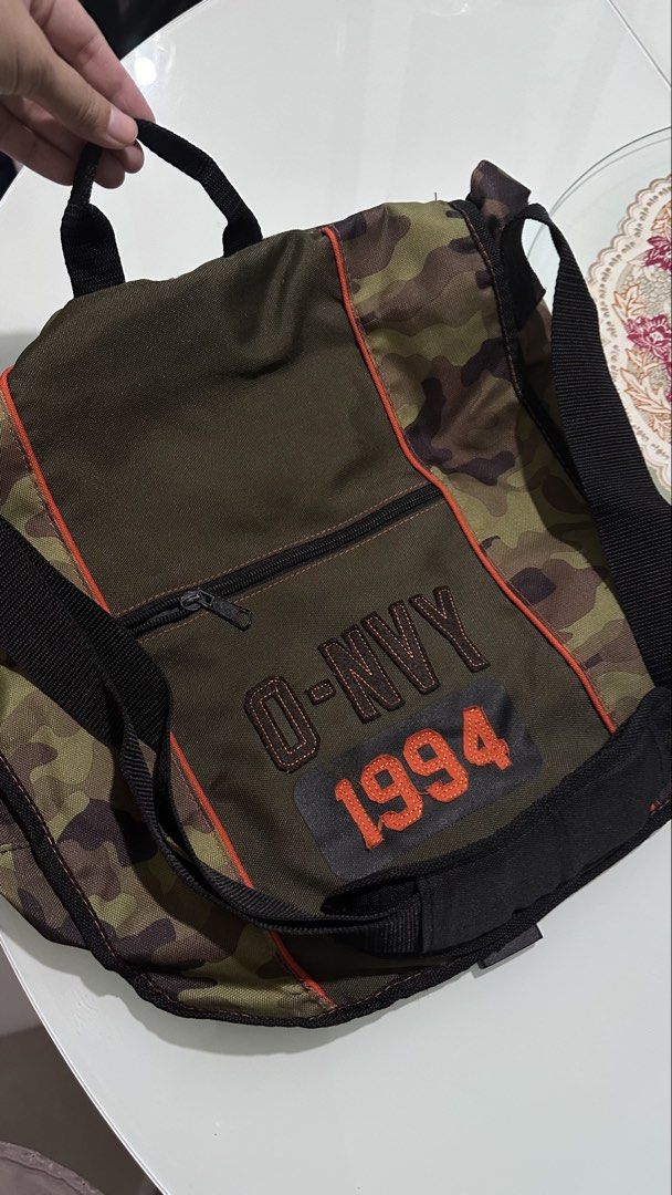 Old Navy Camo Messenger Bag 1994 (Category: Sling Bags) located in Mandaluyong City. Submitted by TheWeekendProject (Listing ID 1461714079, Image 2). Description: - Stylish camo print messenger bag from Old Navy - Features 'O-NVY 1994' embroidery on the front - Adjustable strap for a comfortable fit - Convenient front zipped pocket - Spacious main compartment for all your essentials - Ideal for everyday use, school, or travel.